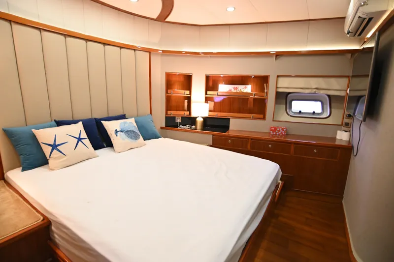  Yacht Photos Pics Luxurious bedroom interior on 2014 Accelera 82 yacht with elegant decor and ocean-themed pillows.
