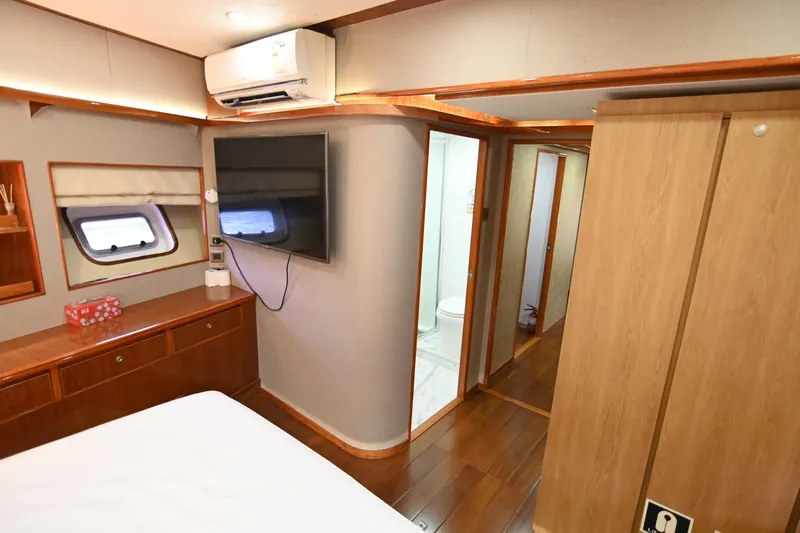  Yacht Photos Pics Luxurious yacht interior with wood accents, TV, and air conditioning, Accelera 82, 2014 model.