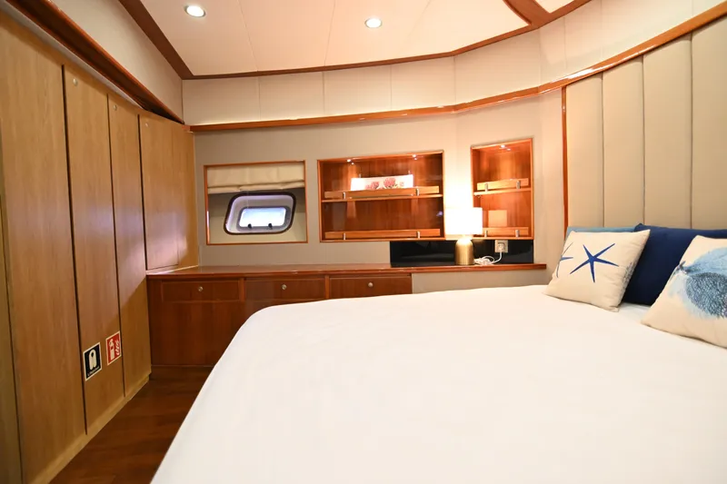  Yacht Photos Pics Luxurious bedroom interior on 2014 Accelera 82 yacht with wood paneling and nautical decor.