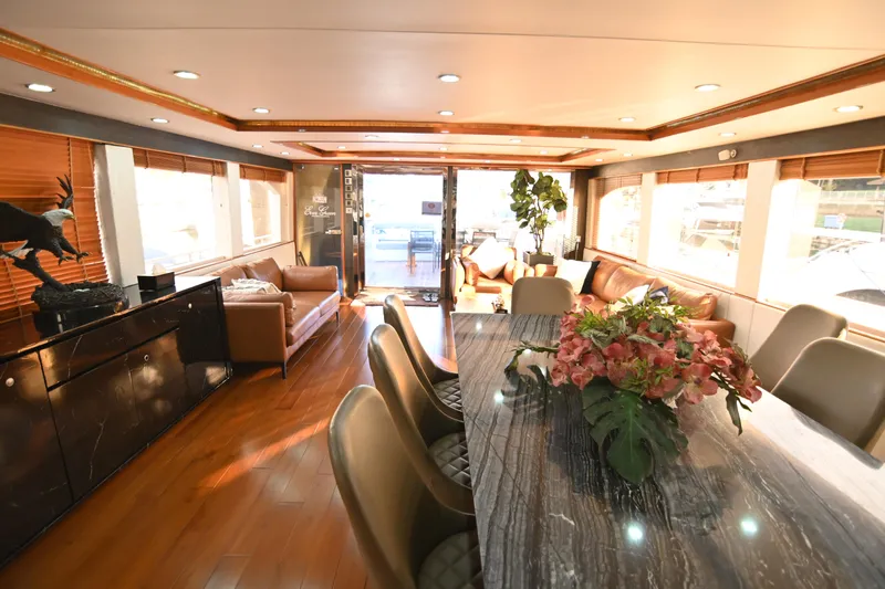  Yacht Photos Pics Luxurious yacht interior with elegant dining area, leather seating, and floral centerpiece, Accelera 82, 2014.