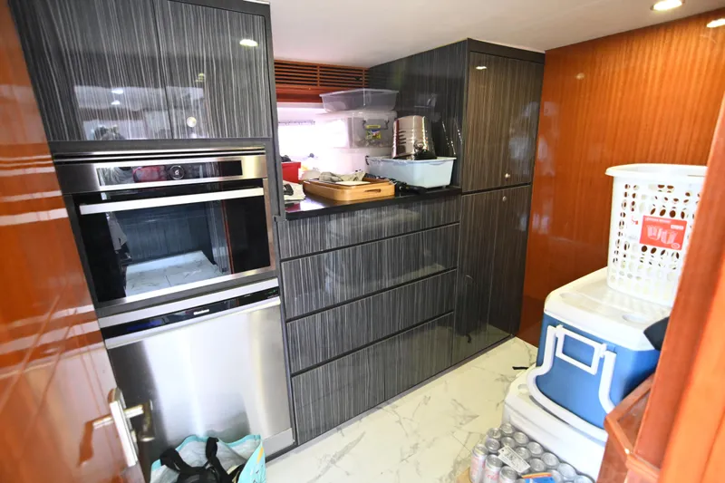  Yacht Photos Pics Modern kitchen with sleek cabinets, stainless steel appliances, and organized storage in a 2014 Accelera 82.