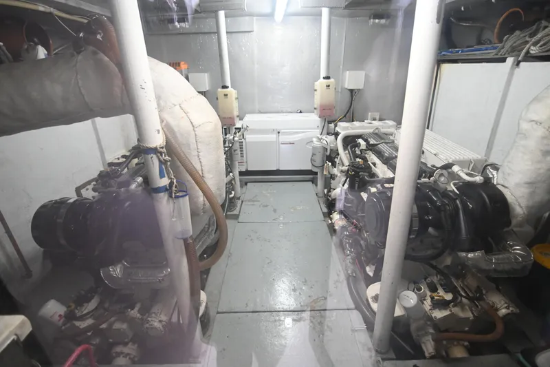  Yacht Photos Pics Engine room of a 2014 Accelera 82 yacht, featuring dual engines and maintenance equipment.