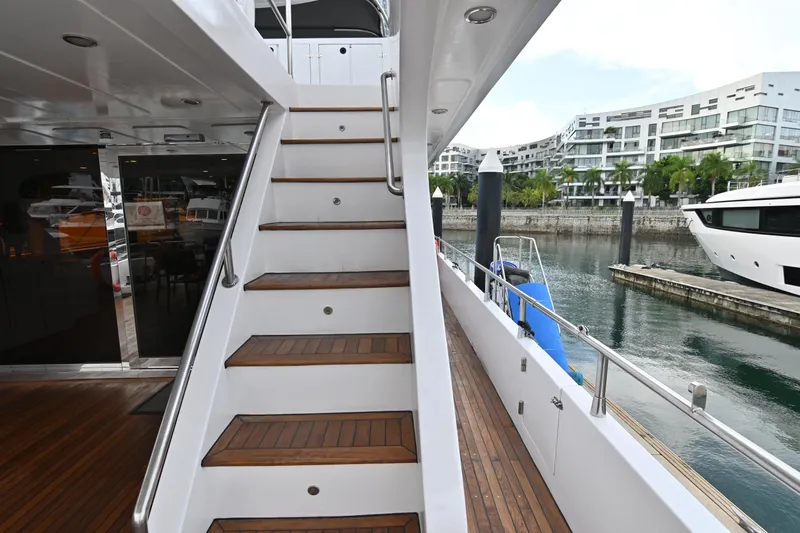  Yacht Photos Pics Staircase on 2014 Accelera 82 yacht docked at marina with modern buildings.