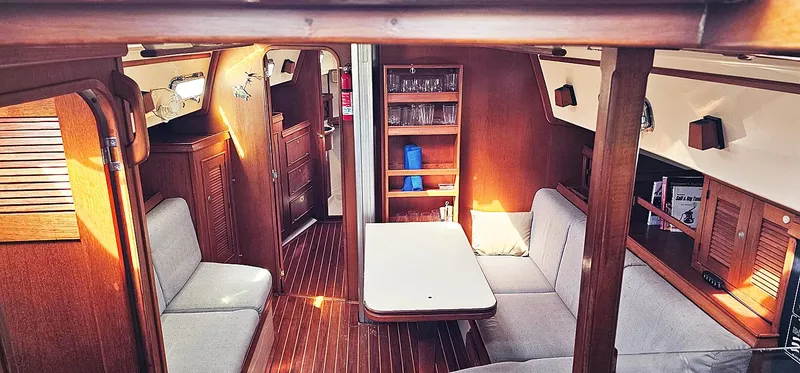 Kewaydin Yacht Photos Pics Interior of 1997 Island Packet 40 sailboat with cozy seating and wooden finishes.