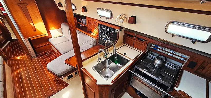 Kewaydin Yacht Photos Pics Interior of 1997 Island Packet 40 sailboat with wood finish and modern kitchen amenities.