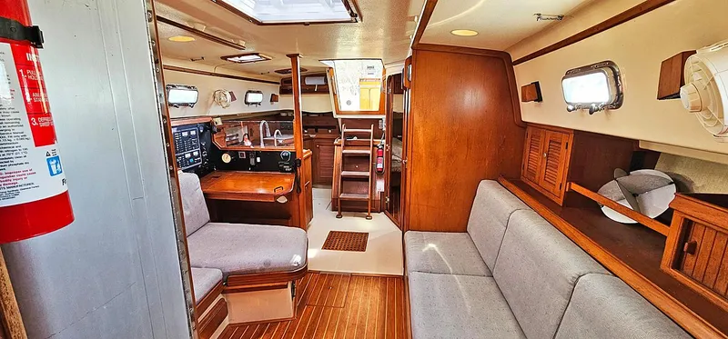 Kewaydin Yacht Photos Pics Interior of 1997 Island Packet 40 sailboat with wood finish and seating area.
