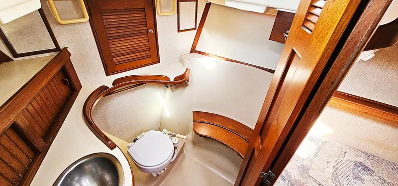 Kewaydin Yacht Photos Pics 1997 Island Packet 40 yacht bathroom with wooden accents and compact design.
