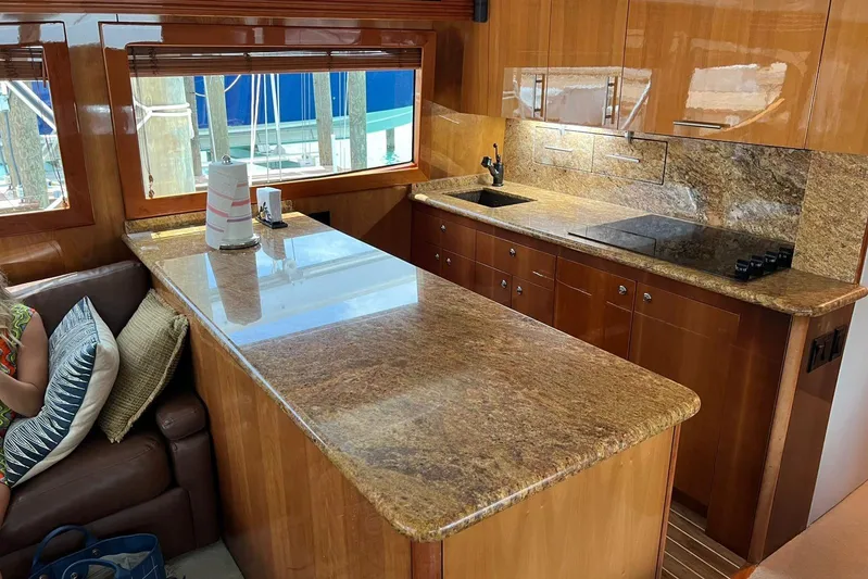  Yacht Photos Pics Luxurious kitchen interior of 2006 Hatteras 54 Convertible yacht with granite countertops.