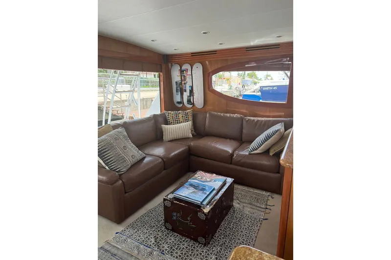  Yacht Photos Pics Luxurious interior of 2006 Hatteras 54 Convertible yacht with leather seating and decorative pillows.