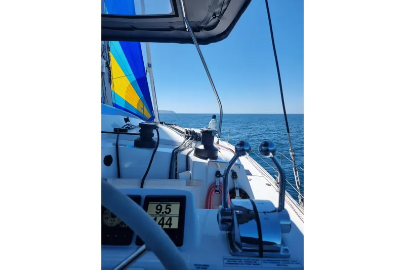 Free To Be Yacht Photos Pics 2022 Fountaine Pajot Elba 45 Catamaran sailing with colorful spinnaker on open sea.