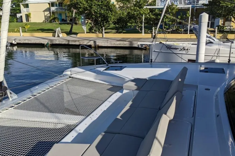 Free To Be Yacht Photos Pics 2022 Fountaine Pajot Elba 45 Catamaran docked, featuring spacious deck and seating area.