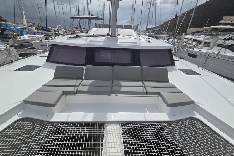 Free To Be Yacht Photos Pics 2022 Fountaine Pajot Elba 45 Catamaran with spacious deck seating in a marina.