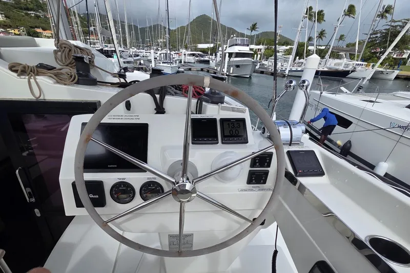 Free To Be Yacht Photos Pics Helm of 2022 Fountaine Pajot Elba 45 Catamaran in marina, featuring navigation instruments.
