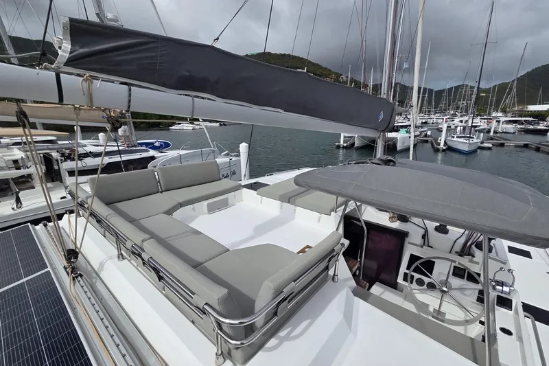Free To Be Yacht Photos Pics 2022 Fountaine Pajot Elba 45 Catamaran docked, featuring spacious deck and seating area.