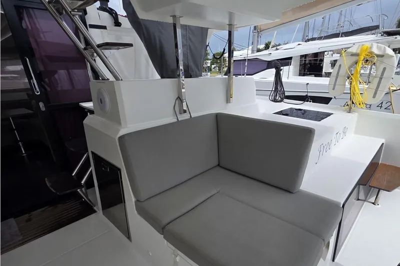 Free To Be Yacht Photos Pics 2022 Fountaine Pajot Elba 45 Catamaran interior with gray seating and modern design.