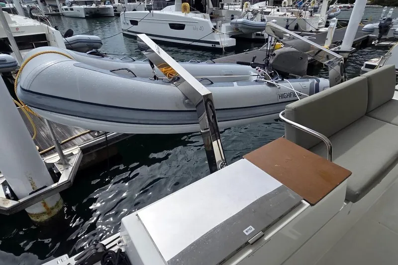 Free To Be Yacht Photos Pics 2022 Fountaine Pajot Elba 45 Catamaran with dinghy at marina dock.
