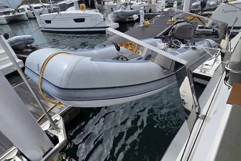 Free To Be Yacht Photos Pics 2022 Fountaine Pajot Elba 45 Catamaran with inflatable dinghy at marina.