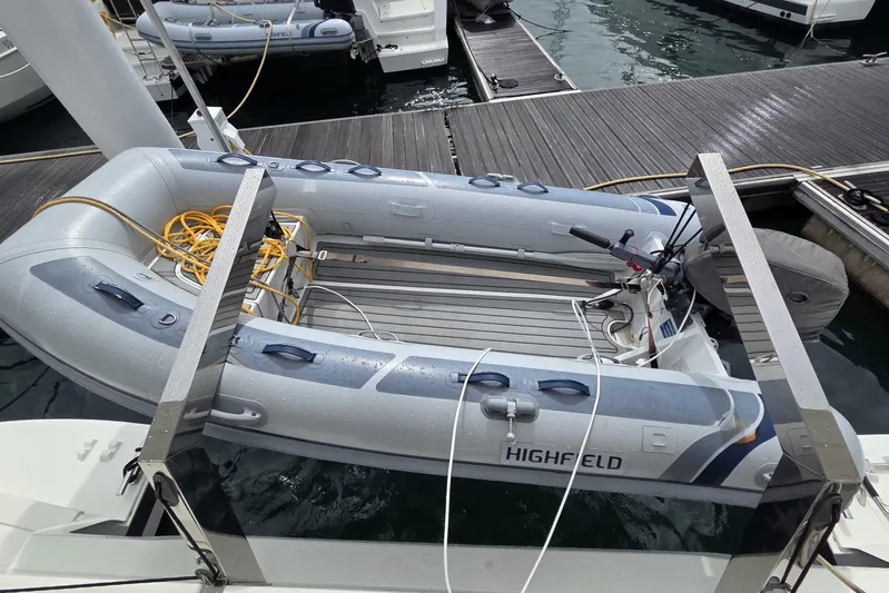 Free To Be Yacht Photos Pics Inflatable dinghy on a 2022 Fountaine Pajot Elba 45 Catamaran, docked at a marina.