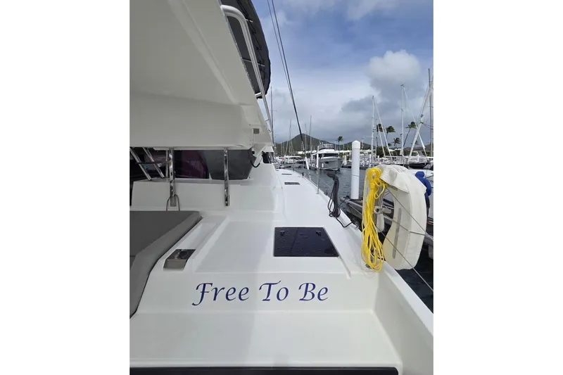 Free To Be Yacht Photos Pics 2022 Fountaine Pajot Elba 45 Catamaran docked, featuring "Free To Be" text on deck.