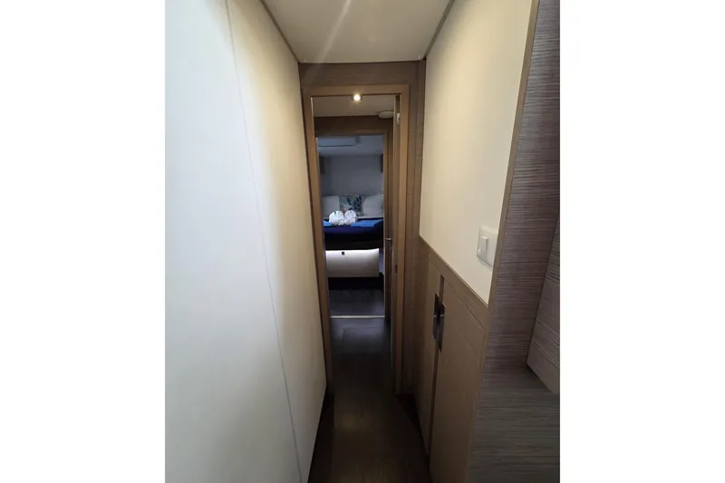 Free To Be Yacht Photos Pics Hallway leading to a cozy bedroom in a 2022 Fountaine Pajot Elba 45 Catamaran.