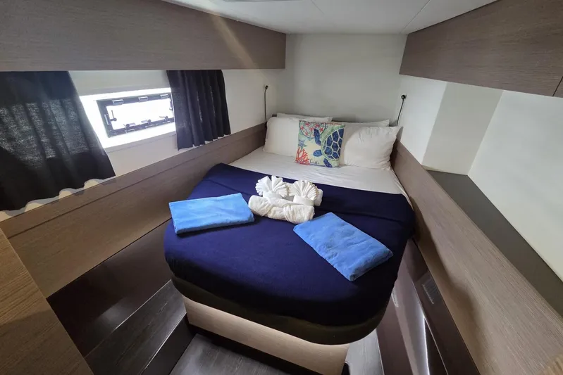 Free To Be Yacht Photos Pics Luxurious cabin interior of 2022 Fountaine Pajot Elba 45 Catamaran with cozy bedding.
