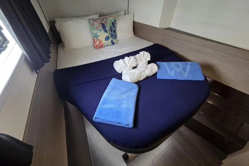 Free To Be Yacht Photos Pics Cozy bedroom in 2022 Fountaine Pajot Elba 45 Catamaran with elegant bedding and towels.