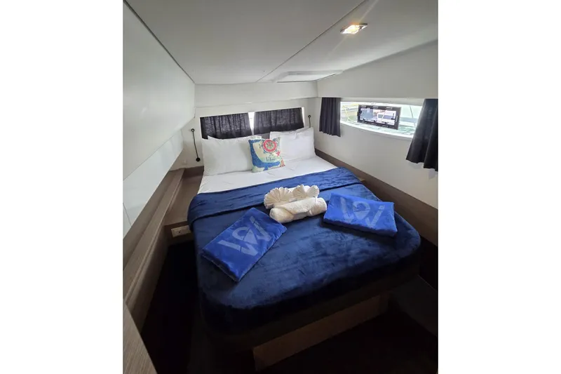 Free To Be Yacht Photos Pics Luxurious cabin interior of 2022 Fountaine Pajot Elba 45 Catamaran with cozy bedding.