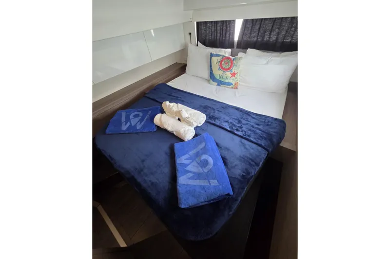 Free To Be Yacht Photos Pics Luxurious bedroom in 2022 Fountaine Pajot Elba 45 Catamaran with blue bedding and nautical decor.