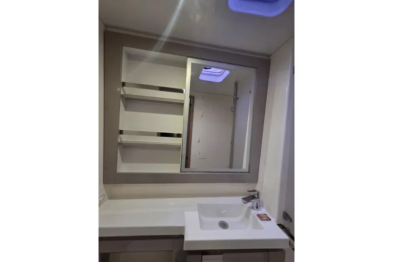 Free To Be Yacht Photos Pics Modern bathroom interior of 2022 Fountaine Pajot Elba 45 Catamaran with sink and mirror.