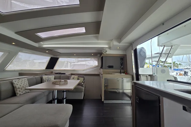 Free To Be Yacht Photos Pics Luxurious interior of 2022 Fountaine Pajot Elba 45 Catamaran with modern seating and skylights.