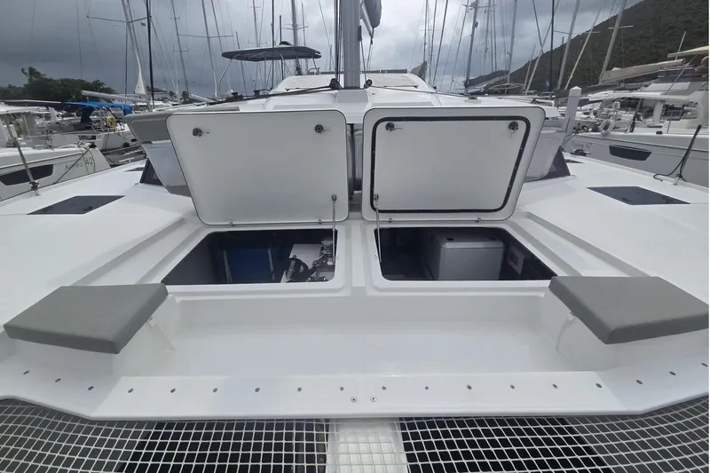 Free To Be Yacht Photos Pics 2022 Fountaine Pajot Elba 45 Catamaran with open storage compartments at marina.