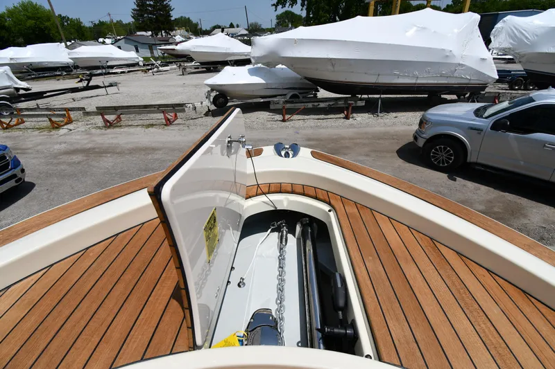  Yacht Photos Pics 2024 Chris-Craft Catalina 30 boat with open anchor hatch, parked in a marina.