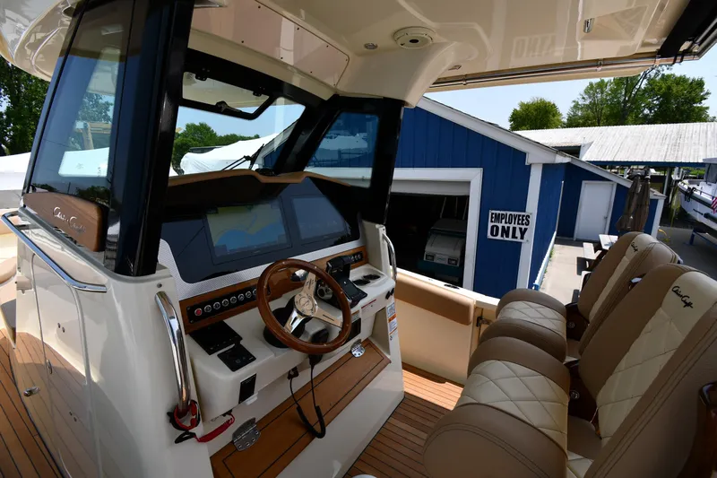  Yacht Photos Pics 2024 Chris-Craft Catalina 30 helm with luxurious seating and advanced navigation controls.