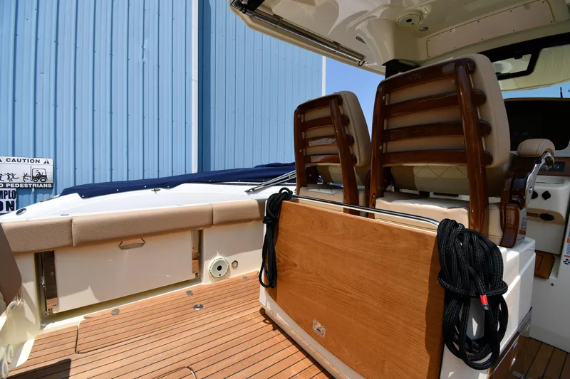  Yacht Photos Pics 2024 Chris-Craft Catalina 30 interior with wooden deck and seating, showcasing luxury design.