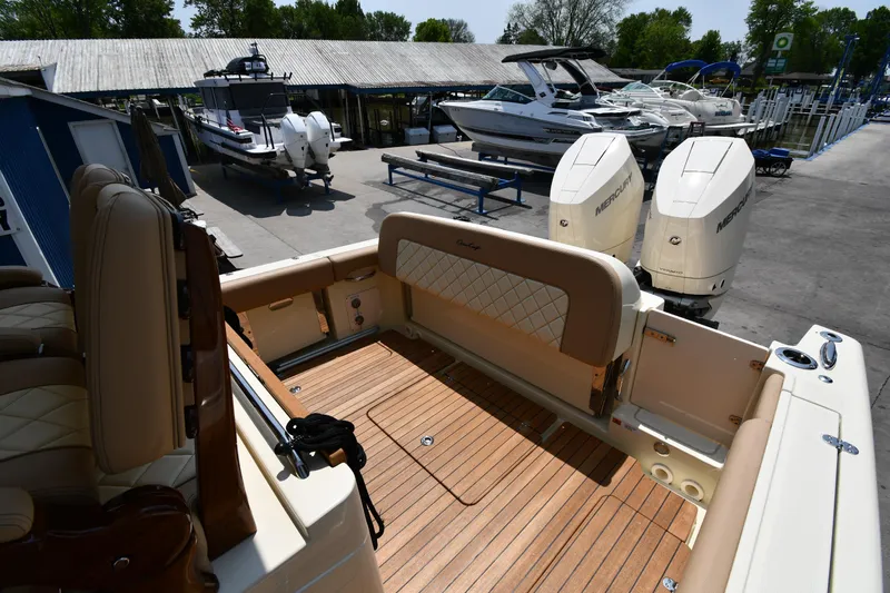  Yacht Photos Pics 2024 Chris-Craft Catalina 30 boat interior with teak flooring and dual outboard engines.