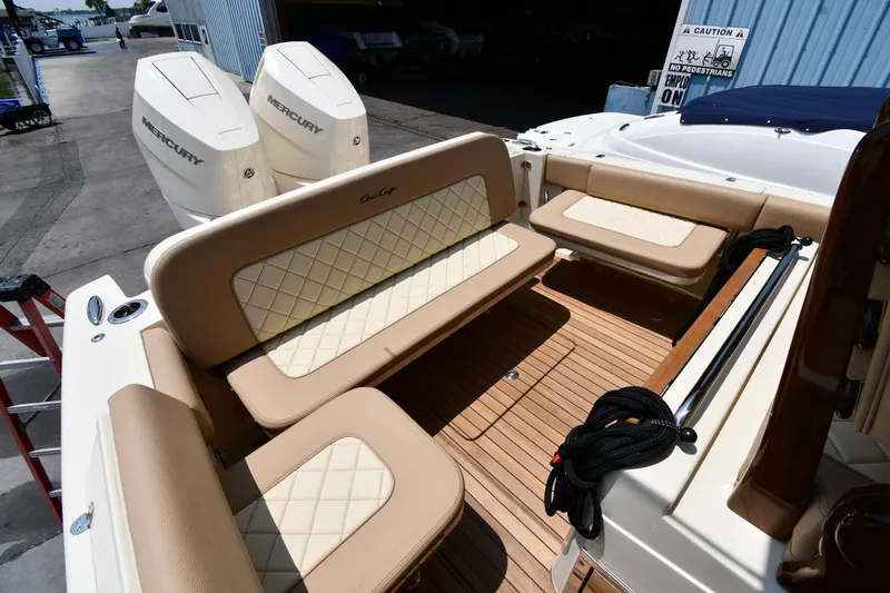  Yacht Photos Pics 2024 Chris-Craft Catalina 30 interior with beige seating and twin Mercury outboard engines.