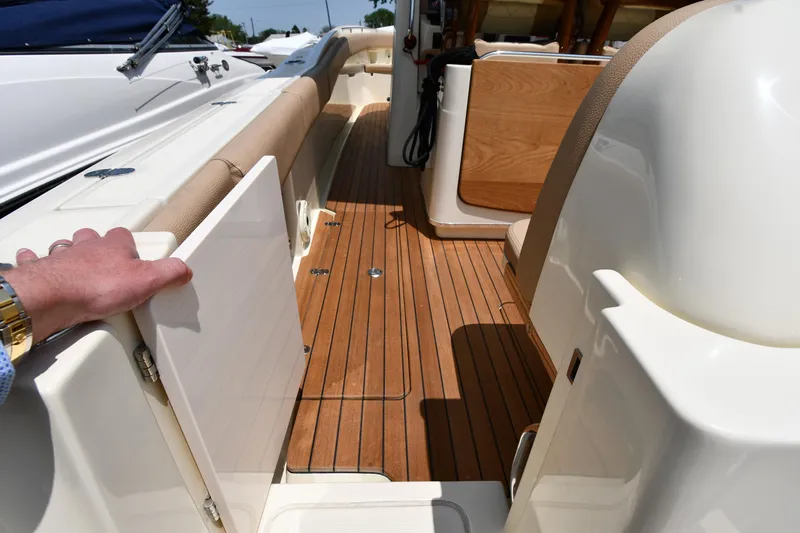  Yacht Photos Pics 2024 Chris-Craft Catalina 30 boat interior with teak flooring and elegant seating.