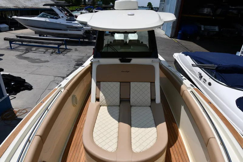  Yacht Photos Pics 2024 Chris-Craft Catalina 30 boat with elegant seating and sleek design at a marina.