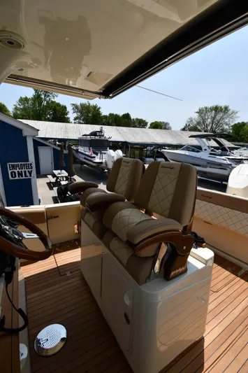  Yacht Photos Pics 2024 Chris-Craft Catalina 30 boat interior with luxurious seating and wooden deck.