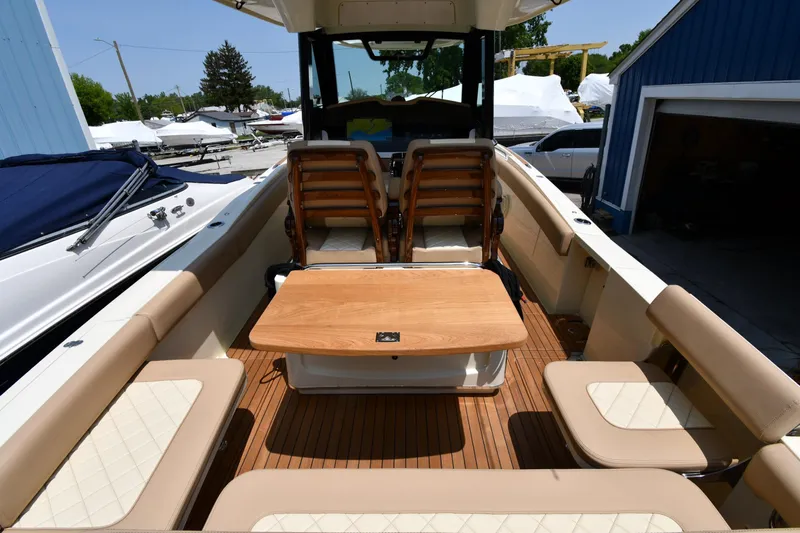  Yacht Photos Pics 2024 Chris-Craft Catalina 30 boat interior with seating and wooden table.