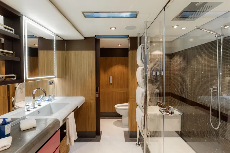 Renegade Yacht Photos Pics Luxurious yacht bathroom with modern fixtures, glass shower, and elegant wood accents, 1992 Lloyds Ships Custom.