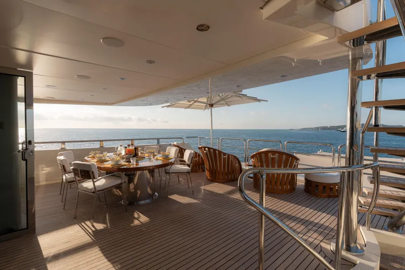 Renegade Yacht Photos Pics Luxurious 1992 Lloyds Ships Custom yacht deck with dining area and ocean view.
