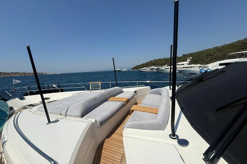  Yacht Photos Pics 2014 Princess Flybridge 82 Motor Yacht with spacious deck seating, docked in scenic waters.