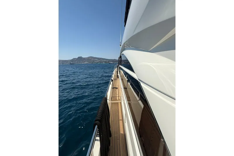  Yacht Photos Pics Side view of a 2014 Princess Flybridge 82 Motor Yacht on open water.