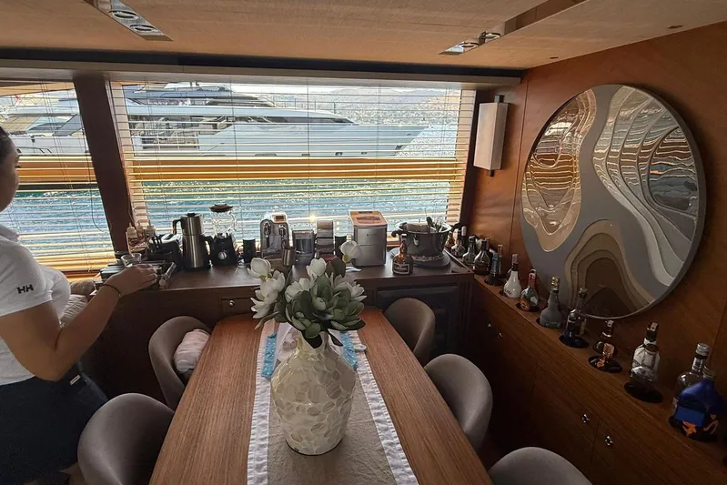  Yacht Photos Pics Luxurious interior of 2014 Princess Flybridge 82 Motor Yacht with dining area and bar setup.