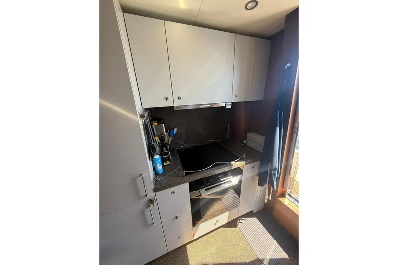  Yacht Photos Pics Compact kitchen in 2014 Princess Flybridge 82 Motor Yacht with modern appliances.