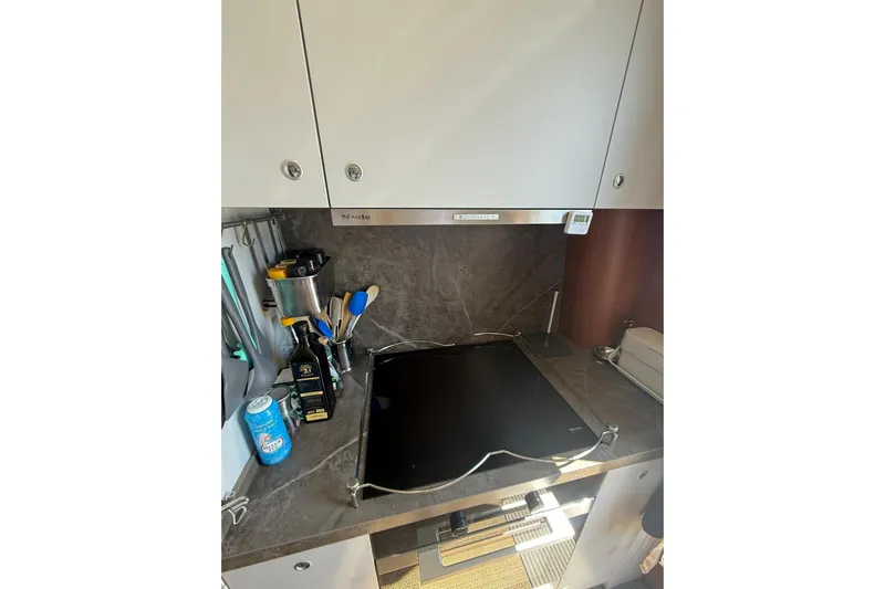  Yacht Photos Pics Modern kitchen area in a 2014 Princess Flybridge 82 Motor Yacht, featuring sleek appliances.