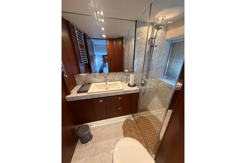  Yacht Photos Pics Luxurious bathroom in 2014 Princess Flybridge 82 Motor Yacht with marble sink and glass shower.