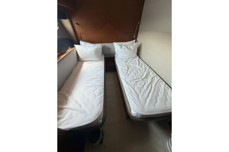  Yacht Photos Pics Twin beds in a 2014 Princess Flybridge 82 Motor Yacht cabin, featuring white bedding.
