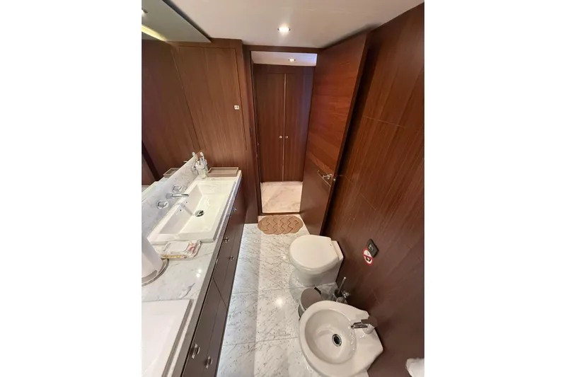  Yacht Photos Pics Luxurious bathroom in 2014 Princess Flybridge 82 Motor Yacht with marble and wood finishes.